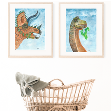 Load image into Gallery viewer, This watercolour dinosaur print set is the perfect addition to any dinosaur lovers room. The natural colouring gives the realistic feel of real dinosaurs in your room. You have the option of a blue or white background, giving you more options to suit your decor. 
